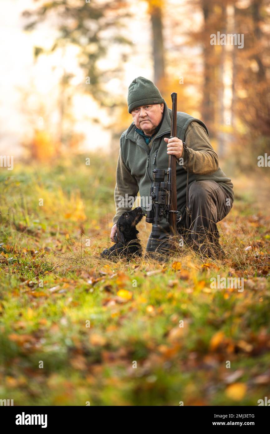 Jäger oder Ranger mit einer professionellen Nachtsichtpistole und Jagdform für die Jagd in einem Herbstwald, Jagdkonzept Stockfoto