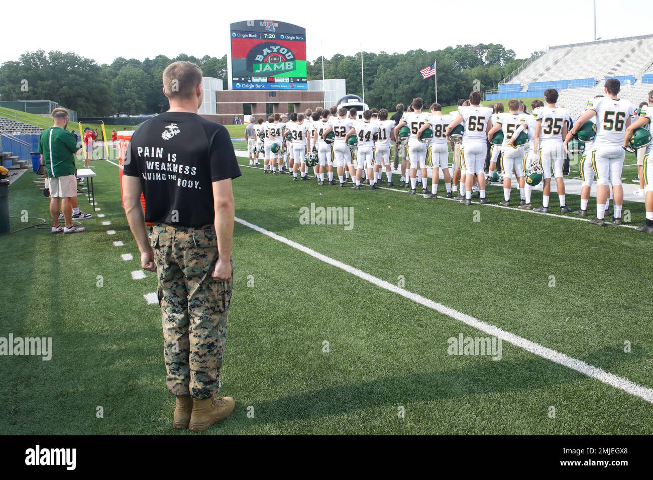 USA Marinekorps Staff Sgt. Isaac Pike steht vor der Flagge, wenn die Nationalhymne vor dem Spiel Cedar Creek gegen Evangel spielt, während der Bayou-Pyjamb im Joe Aillet Stadium an der Louisiana Tech University in Ruston, Louisiana, vom 26. Bis 27. August 2022. Der Jamboree begann 2005 und wurde offiziell 2006 als „Bayou jamb“ bezeichnet. Die Aufgabe des Jamboree besteht darin, den Wert der Teilnahme an Mannschaftssportarten in einer gesunden Umgebung für die Herausforderung des Wettbewerbs, die Freude am Sieg, die Realität der Niederlage, die Bedeutung des Engagements und den Geist der Gemeinschaft und der Teamarbeit zu fördern. Stockfoto