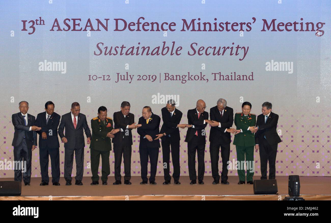 ASEAN defense ministers prepare to join hands for a group photo ahead ...