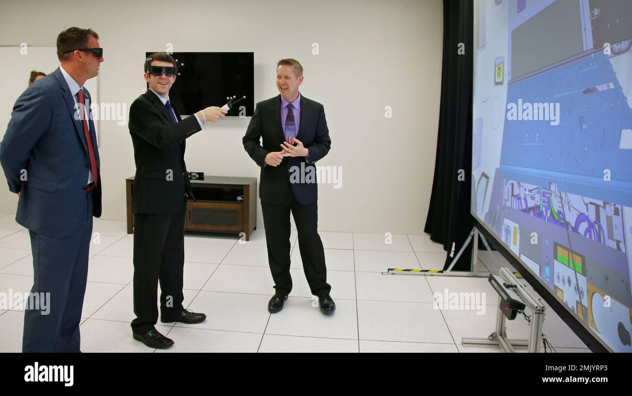 Oklahoma Gov. Kevin Stitt, left, dons 3D glasses to watch a virtual reality presentation of a