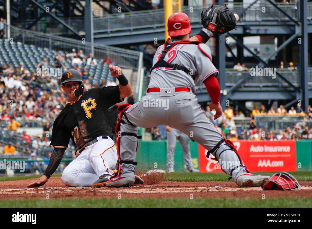 Pittsburgh Pirates' Kevin Newman, left is tagged by Cincinnati Reds