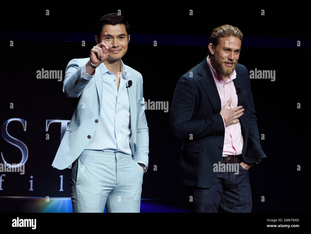 Henry Golding, left, and Charlie Hunnam, cast members in the upcoming film "The Gentlemen," appear during the STXfilms presentation at CinemaCon 2019, the official convention of the National Association of Theatre Owners (NATO) at Caesars Palace, Tuesday, April 2, 2019, in Las Vegas. (Photo by Chris Pizzello/Invision/AP) Stockfoto