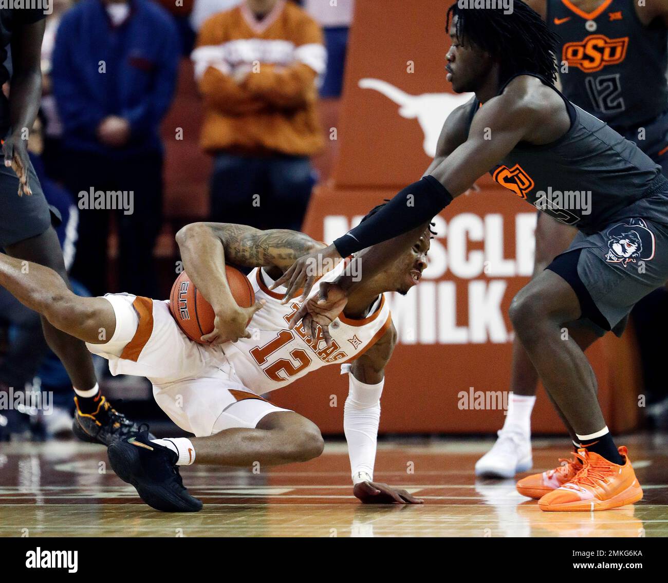 Texas guard Kerwin Roach II (12) grabs a loose ball in front of Oklahoma State guard Isaac Likekele (13) during the first half of an NCAA college basketball game, Saturday, Feb. 16, 2019, in Austin, Texas. (AP Photo/Eric Gay) Stockfoto