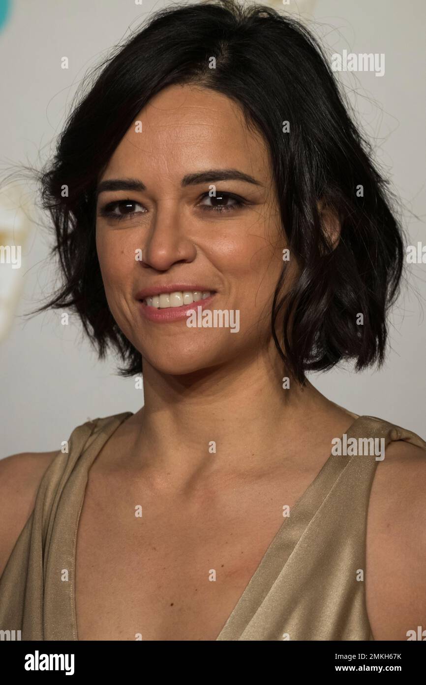 Michelle Rodriguez poses for photographers upon arrival at the BAFTA