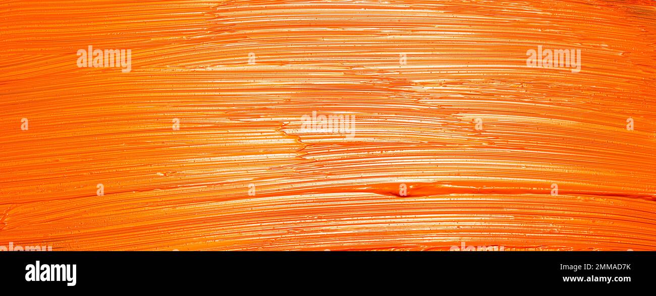 Orangefarbener Pinsel zieht Texturhintergrund Stockfoto