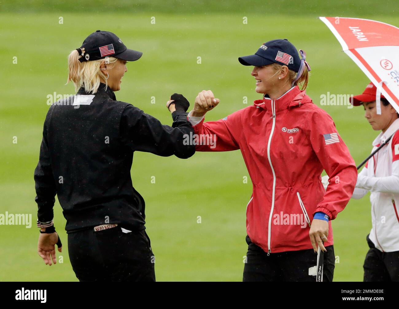 Jessica Korda of the United States reacts with her teammate Michelle Wie, left, on the 5th hole
