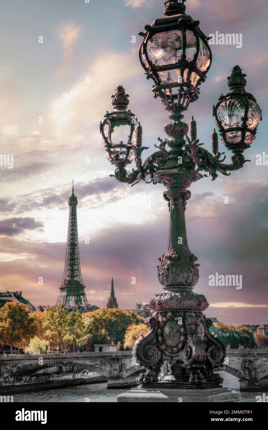 Eine dekorative Laterne schmückt die Brücke Pont Alexandre III mit dem Eiffelturm im Hintergrund in Paris, Frankreich. Stockfoto