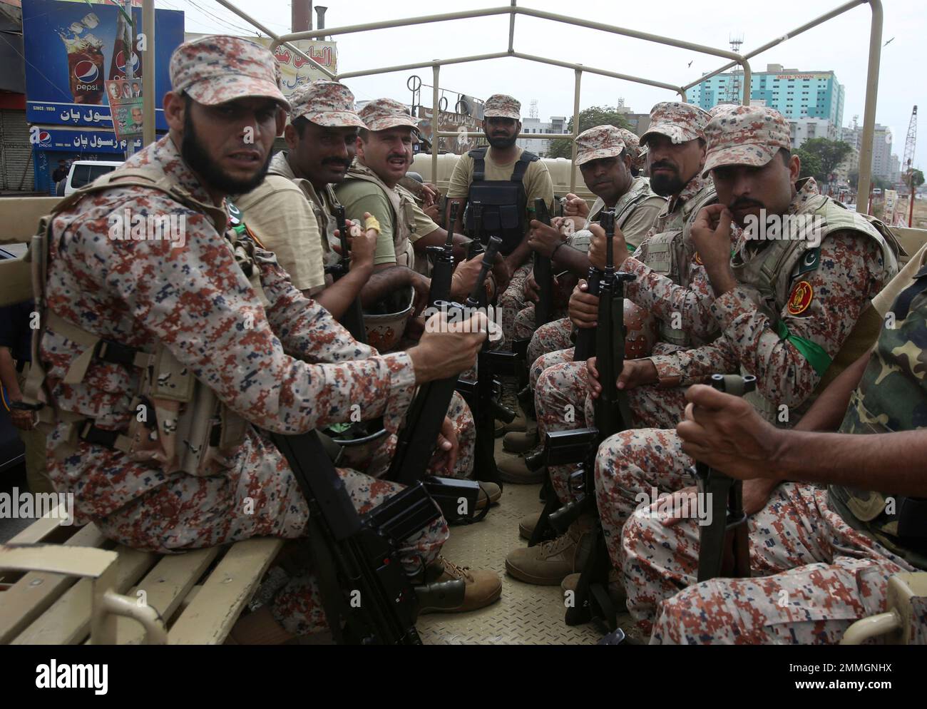 Pakistani soldiers sit guard in a truck during a Muharram procession ...