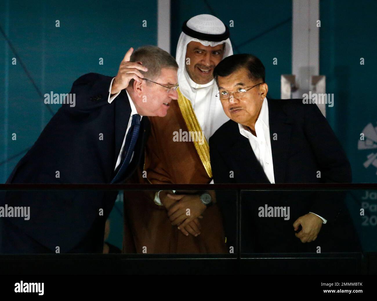 International Olympic Committee (IOC) President Thomas Bach, left, Olympic Council of Asia president Sheikh Ahmad al-Fahad al-Sabah, centre, and Indonesian President Vice President Jusuf Kalla, right, chase as they watch the closing ceremony for the 18th Asian Games in Jakarta, Indonesia, Sunday, Sept. 2, 2018. (AP Photo/Dita Alangkara) Stockfoto