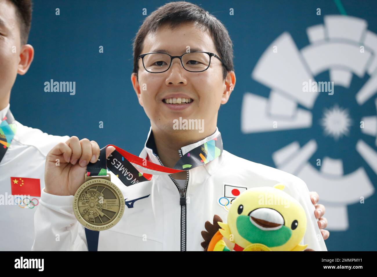 Japan's Takayuki Matsumoto poses with his bonze medal after awards