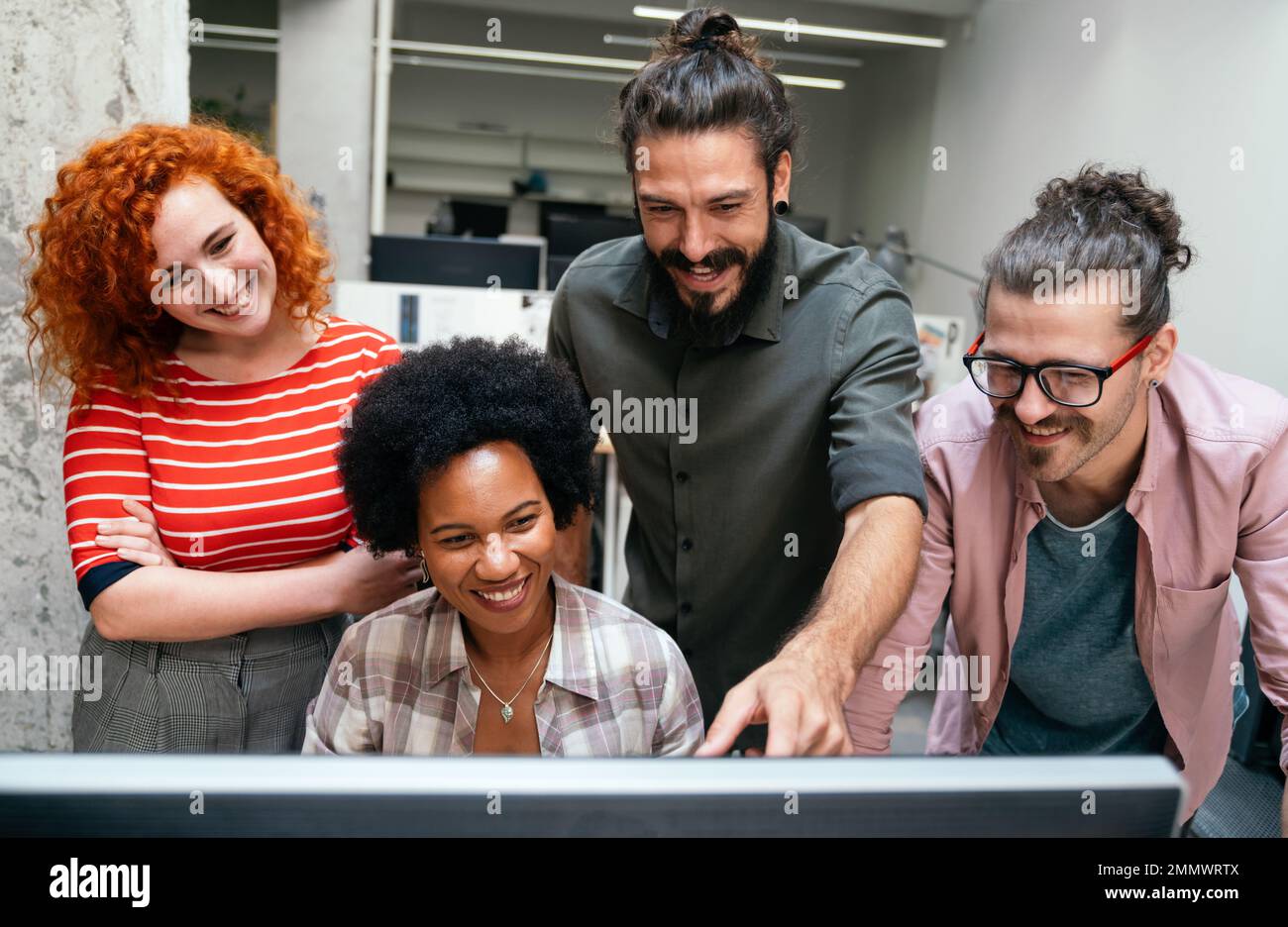 Lächelnd treffen sich verschiedene Kollegen in einem Brainstorming in der Vorstandsetage, um gemeinsam Finanzstatistiken zu diskutieren Stockfoto