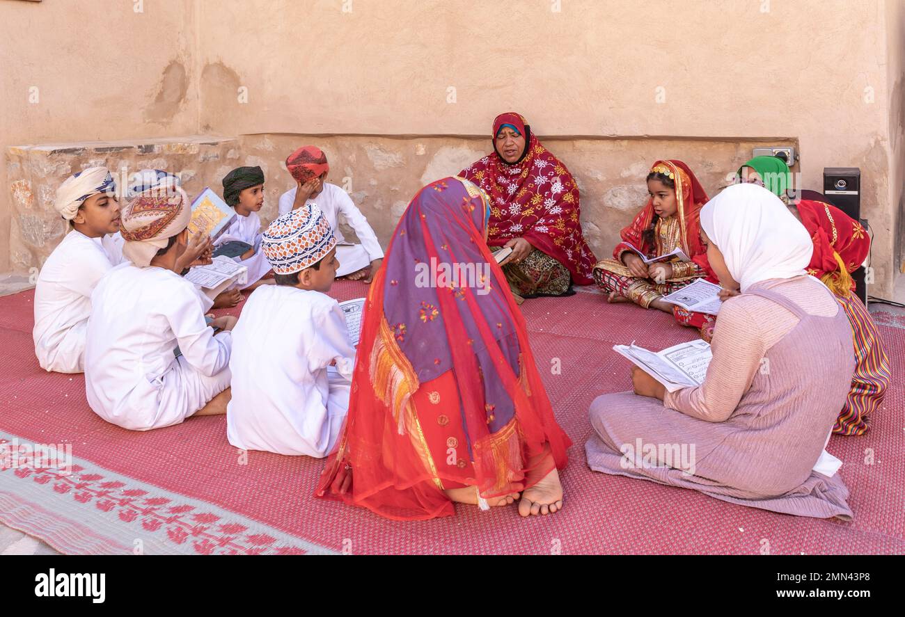 Nizwa, Oman, 2. Dezember 2022: omanische Kinder rezitieren ein heiliges Buch Stockfoto