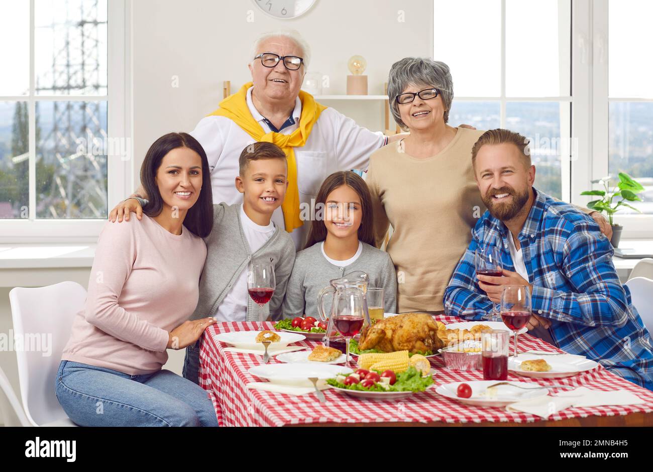 Portrait einer glücklichen Familie von drei Generationen, die gemeinsam Thanksgiving feiern. Stockfoto