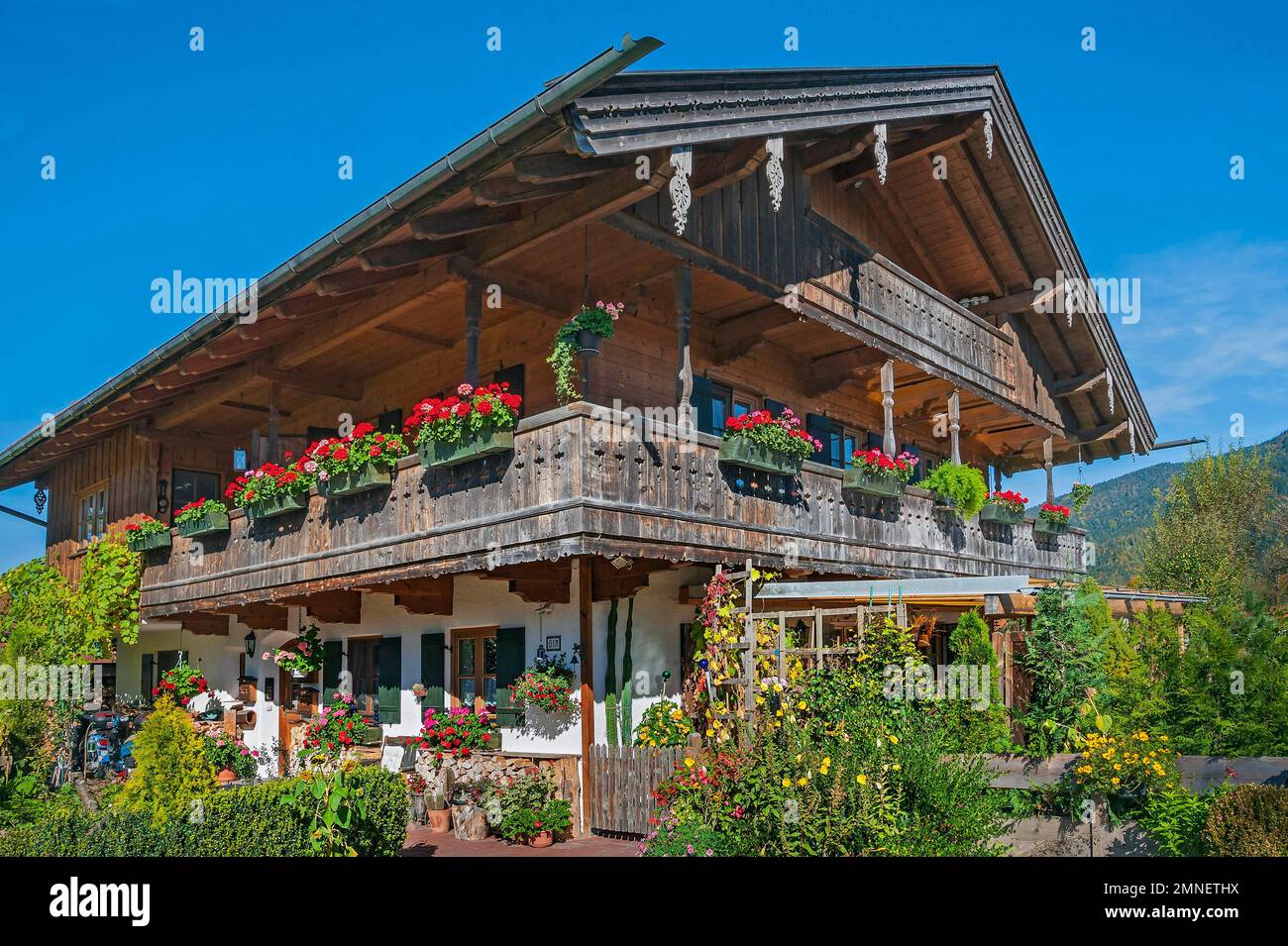 In Wegscheid bei Lenggries, Bayern, umgebautes Bauernhaus mit Blumendekorationen Stockfoto