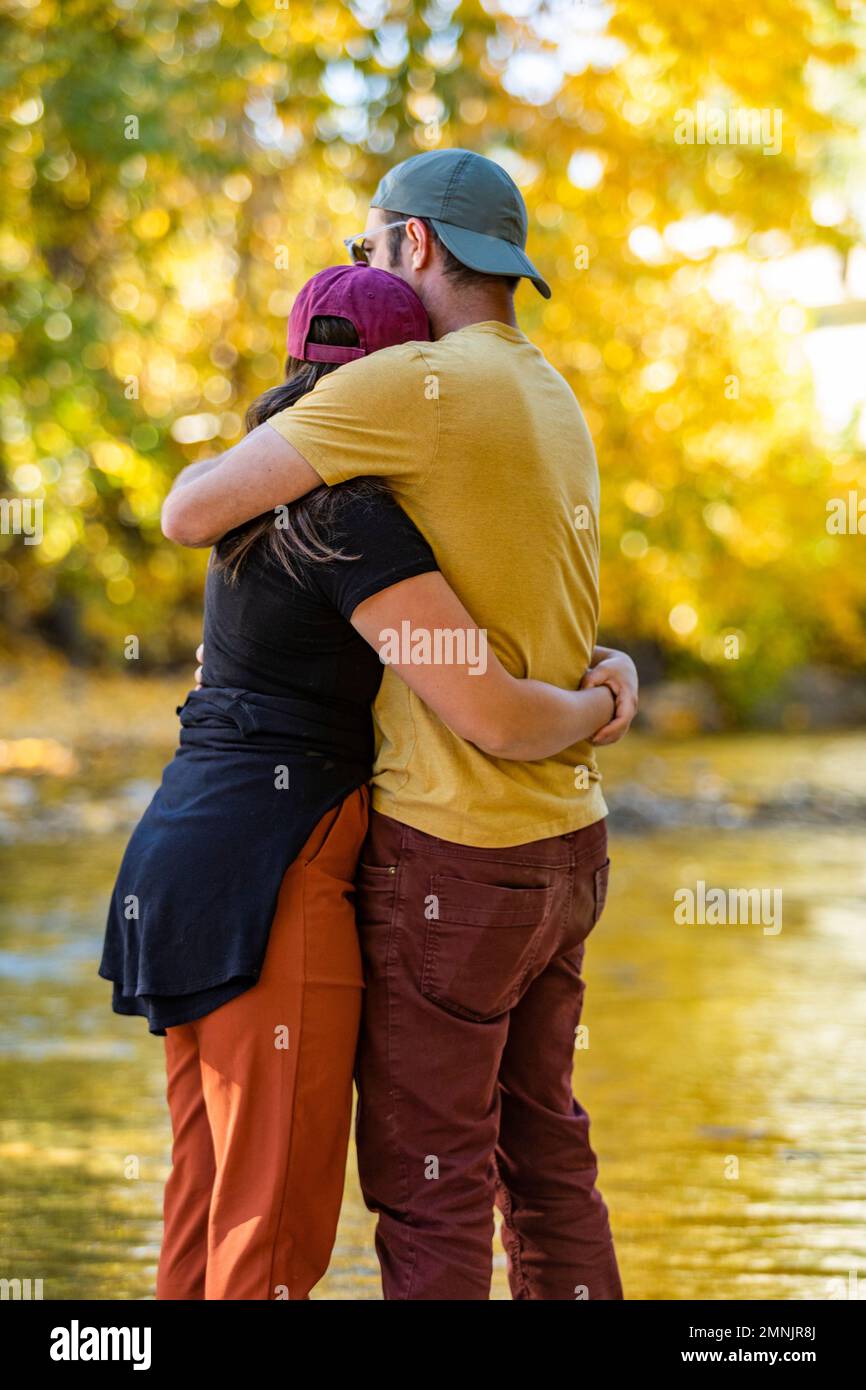 Ein erwachsenes Paar, das sich am Fluss umarmt Stockfoto