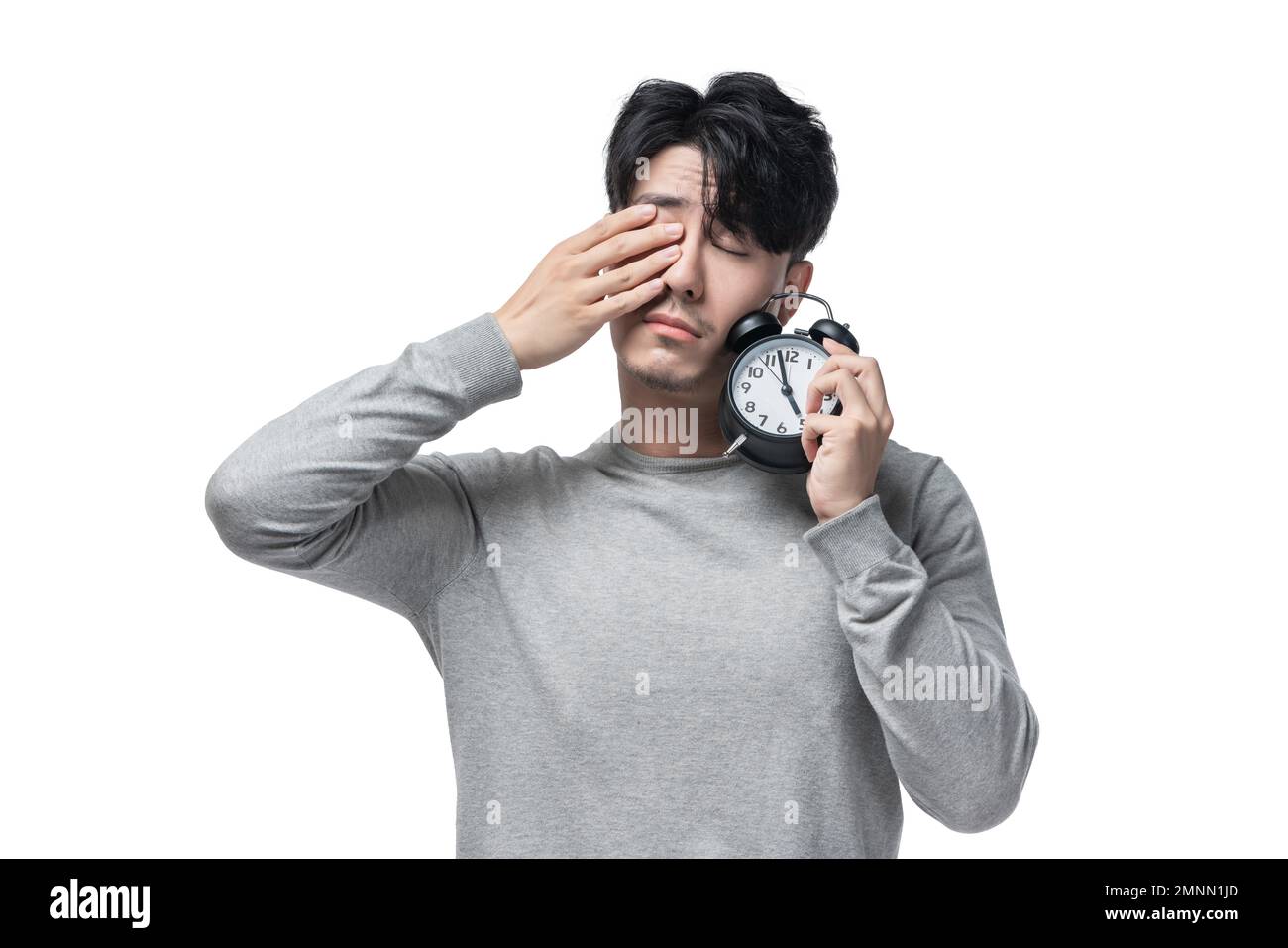 Der junge Mann mit dem Wecker Stockfoto