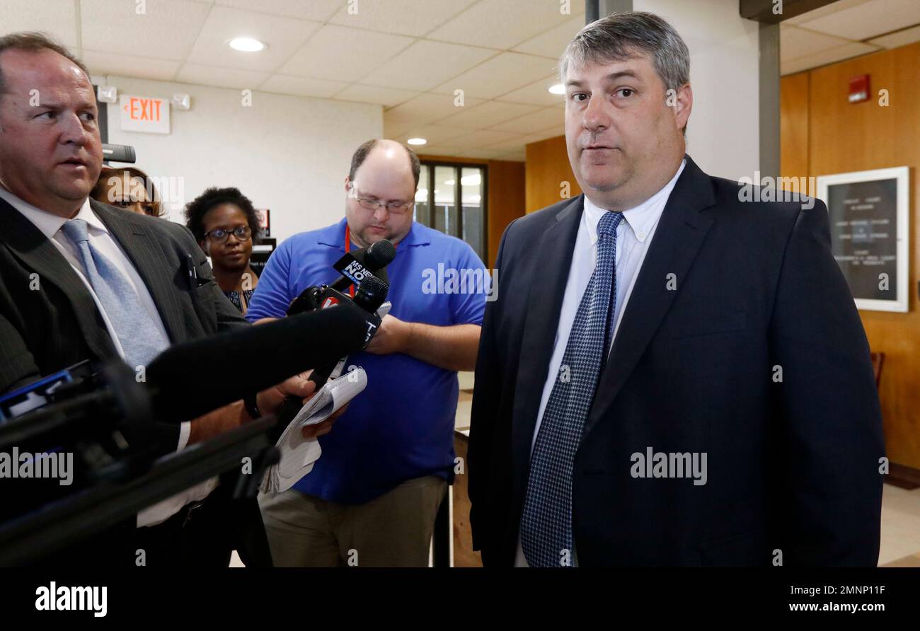 District Attorney Dee Bates speaks with reporters following the