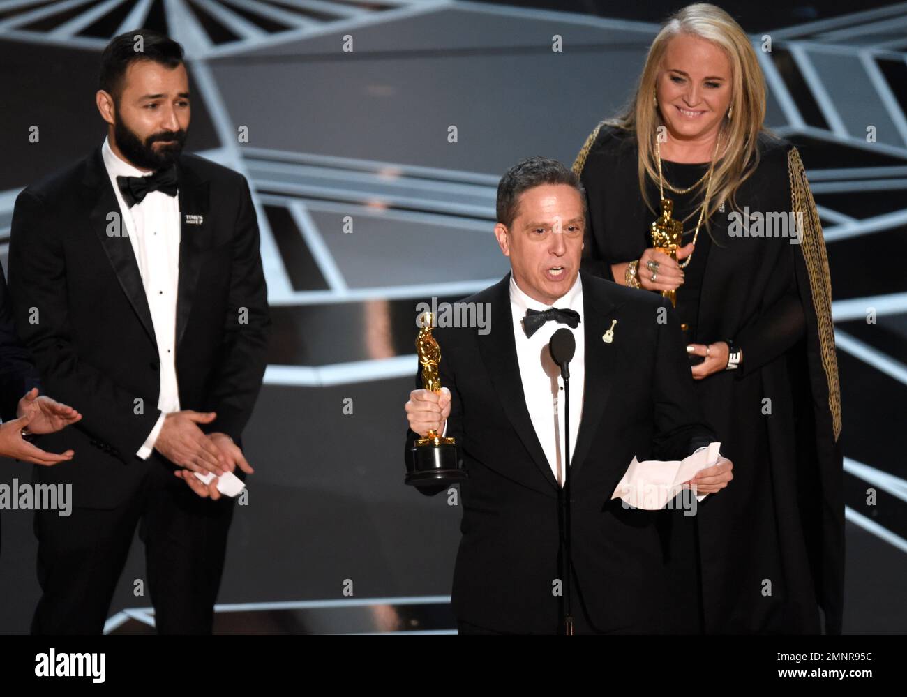 Adrian Molina, from left, Lee Unkrich, and Darla K. Anderson accept the award for best animated feature film for "Coco" at the Oscars on Sunday, March 4, 2018, at the Dolby Theatre in Los Angeles. (Photo by Chris Pizzello/Invision/AP) Stockfoto
