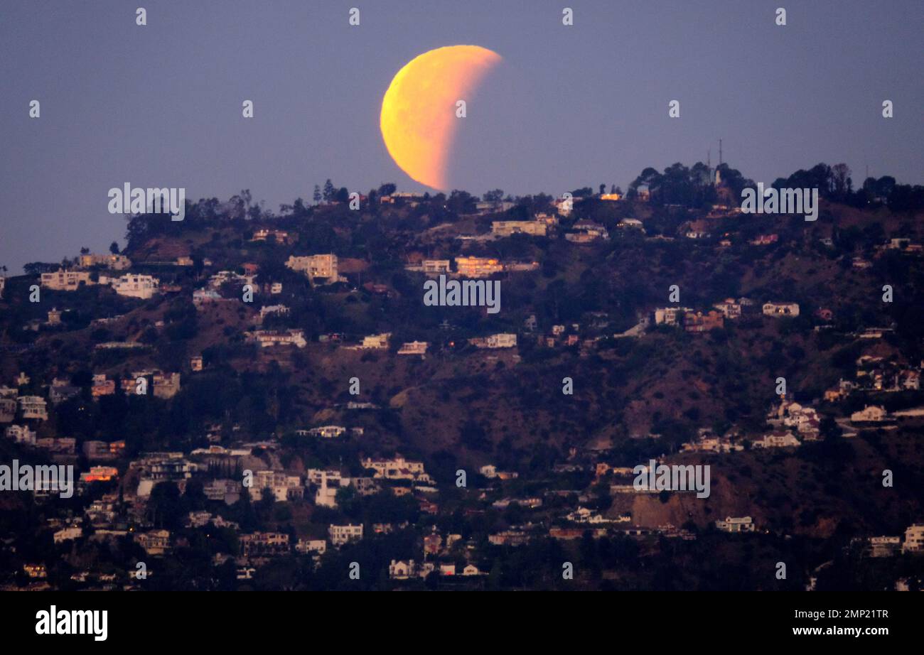 A super blue blood moon is seen setting behind the Hollywood hills in ...