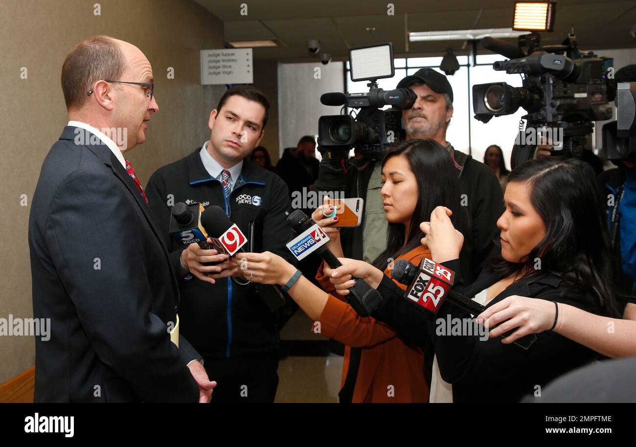 Cleveland County District Attorney Greg Mashburn, left, talks with the