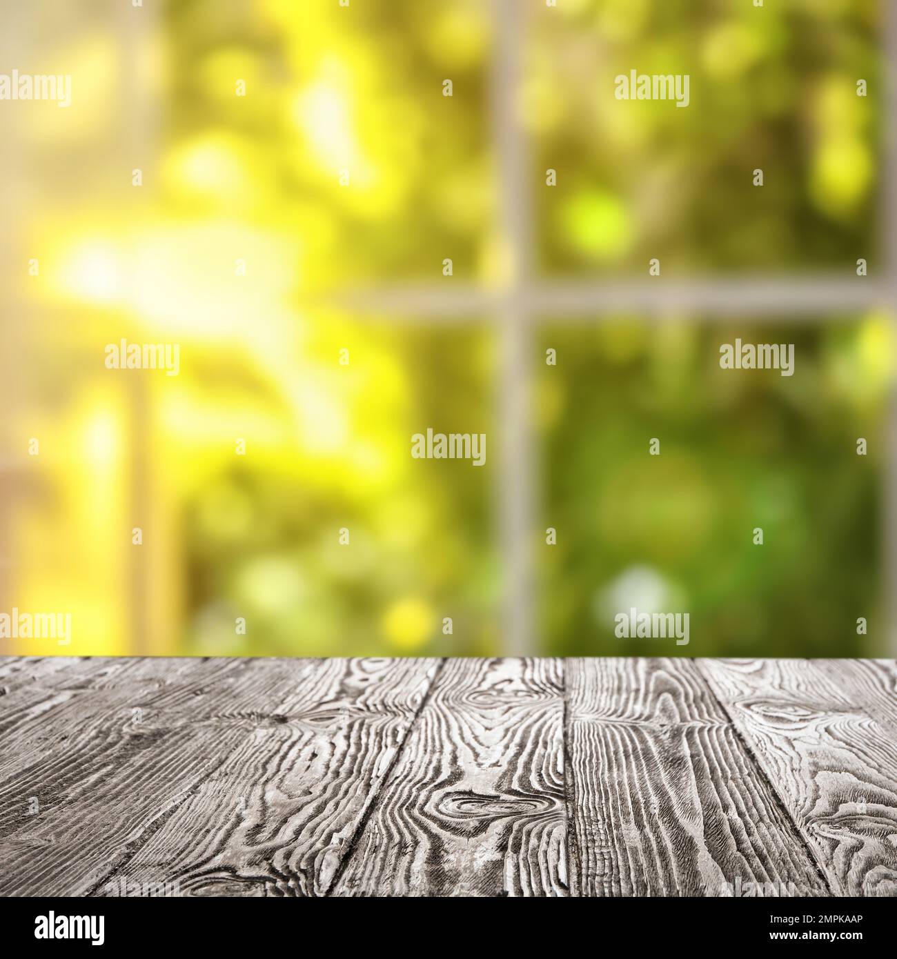 Leerer Holztisch vor dem Fenster. Sonniger Morgen Stockfoto