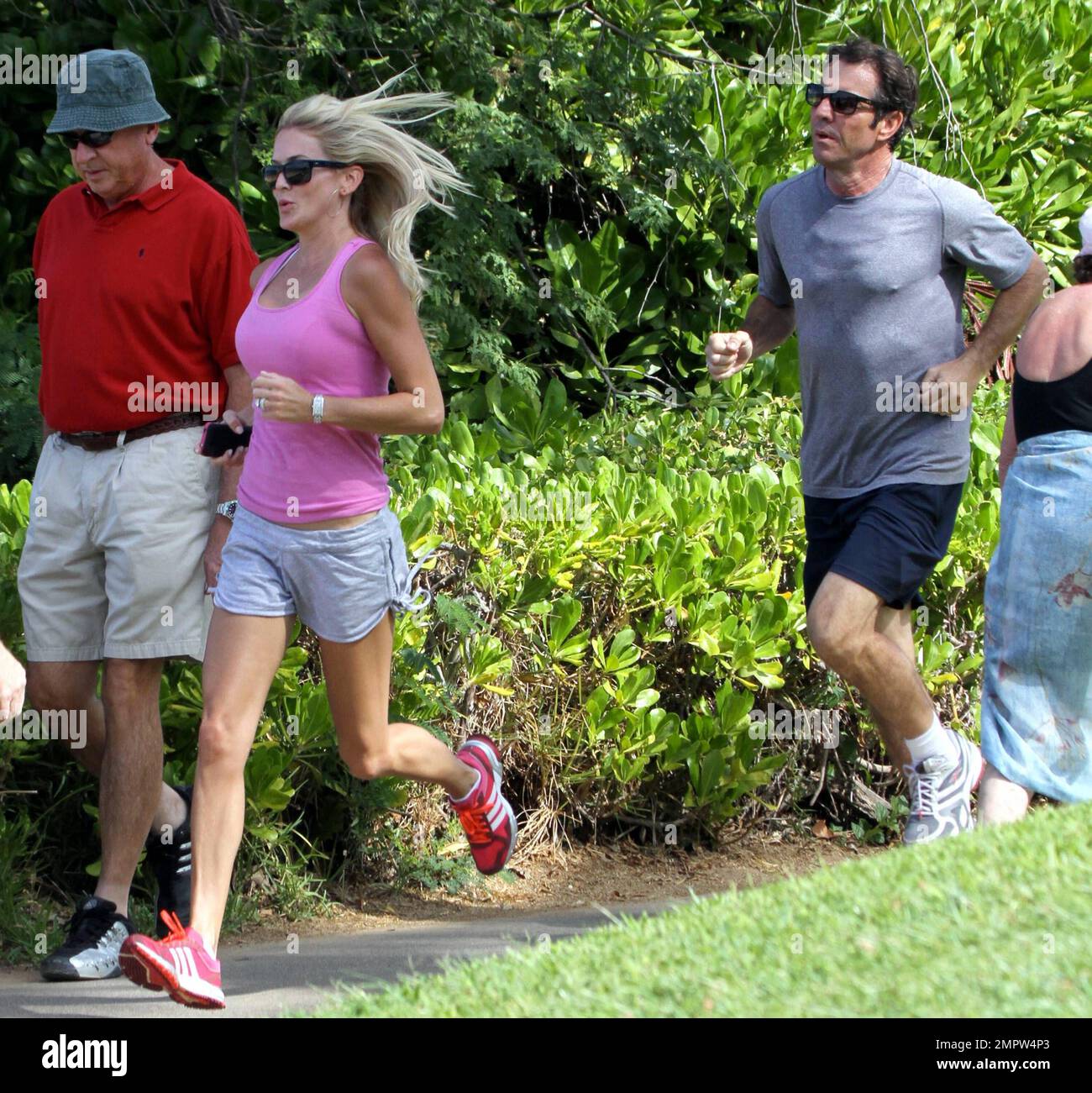 Der gute Schauspieler Dennis Quaid und seine Frau Kimberly Buffington halten während eines hawaiianischen Urlaubs ihre Fitness mit einem Jogging aufrecht. Quaid, der Berichten zufolge seine Montana Ranch Anfang dieser Woche zum Verkauf angeboten hat, sagte kürzlich, er träumt davon, nach Hawaii zu ziehen, um mehr Zeit mit Surfen zu verbringen. Der 57-jährige Star „Footloose“ liebte erstmals das Surfen, als er den Film „Soul Surfer“ drehte, der die Geschichte des Haiangriffsopfers Bethany Hamilton erzählt. Maui, Hi. 26. Oktober 2011. Tel.: +1 305 542 9275 Stockfoto