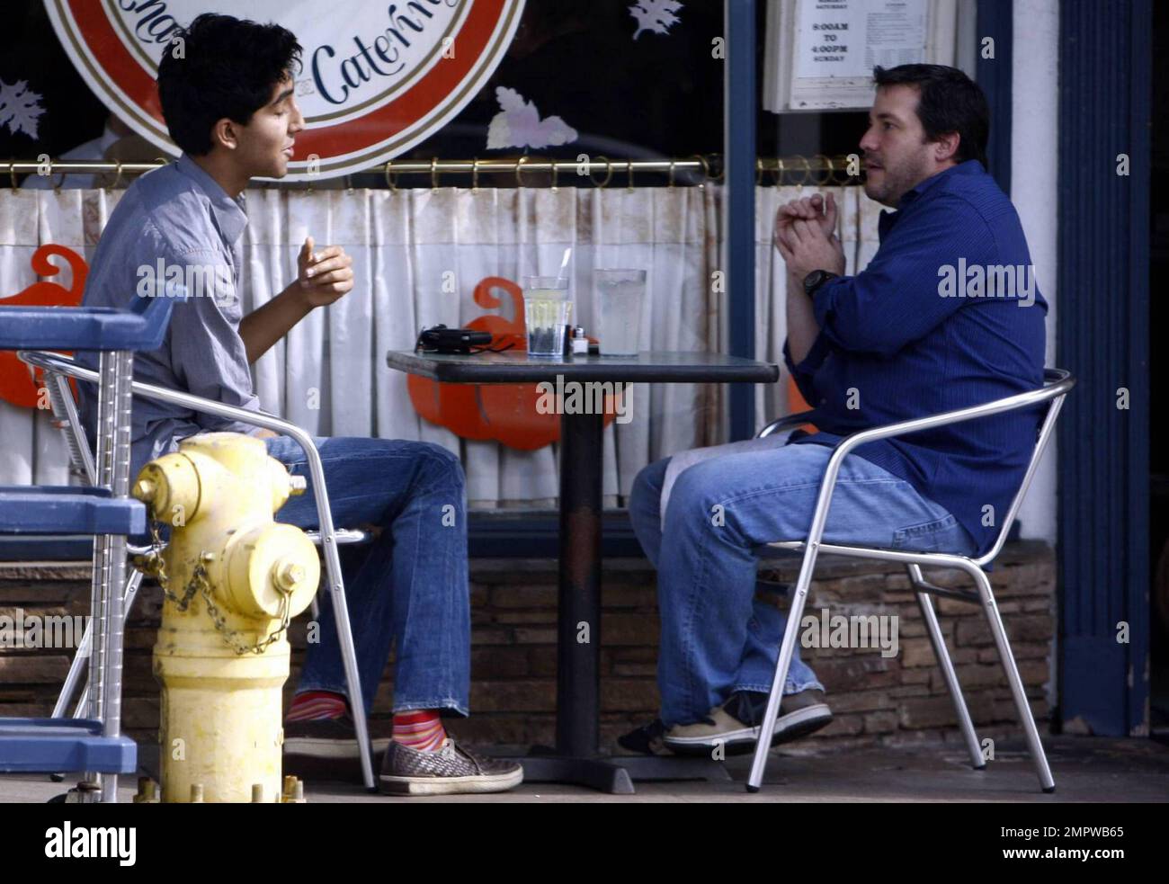 Der britische Schauspieler und Slumdog Millionaire Dev Patel genießen ein Mittagessen und ein Gespräch mit einem Freund bei der Konversation in West Hollywood, Kalifornien. 11/12/09. Stockfoto