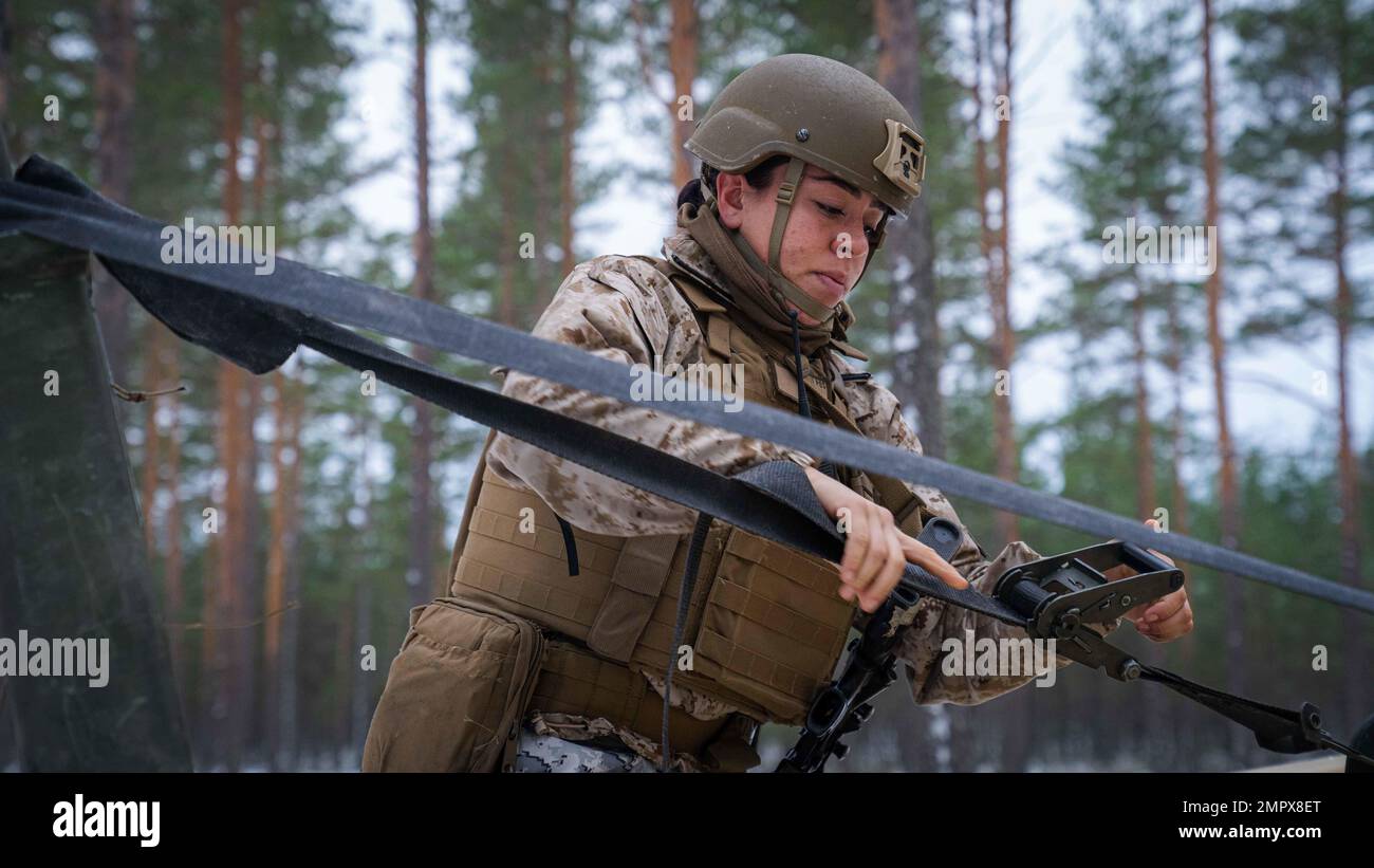 USA Marine Corps Sgt. Andrea Blaine, ein Kraftfahrzeugbetreiber des Combat Logistics Battalion 6 (CLB-6), stellt während eines simulierten Konvoi-Angriffs in Syndalen, Finnland, am 22. November 2022 einen Ratschengurt ein. Task Force Red Cloud mit Hauptsitz von Elementen des CLB-6, Wird in Finnland eingesetzt, um die Übungen SYD 2022 und Freezing Winds 2022 zu unterstützen, um die gegenseitige Abhängigkeit der USA und Finnlands im maritimen Bereich zu verstärken, bilaterale maritime Manöver innerhalb der finnischen Küstenregion zu festigen und enge Beziehungen zwischen den USA zu fördern Marinekorps und finnische Einheiten zur Aufrechterhaltung der Streitkräfte. Stockfoto