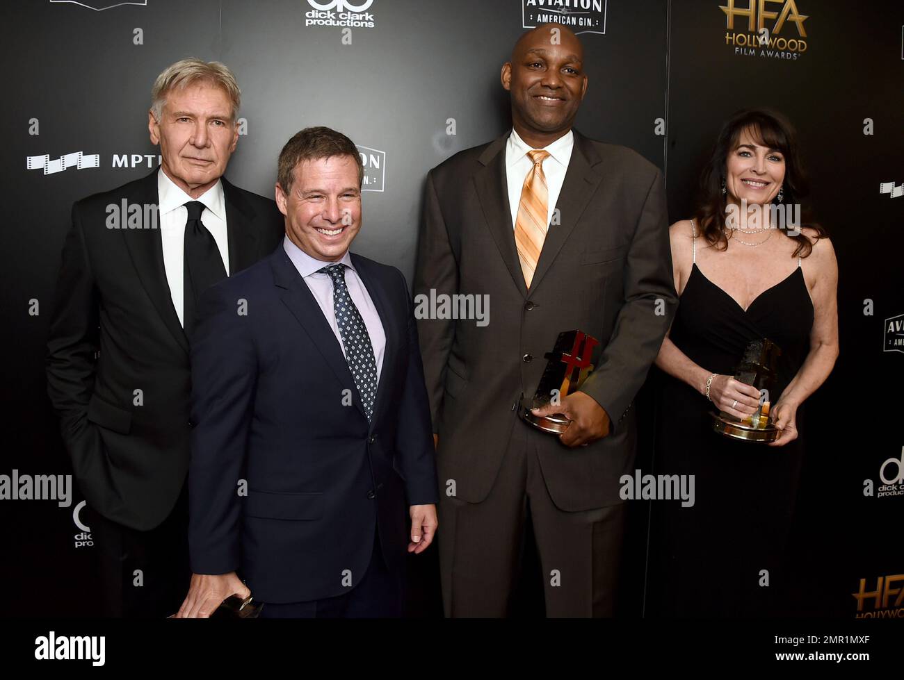 Harrison Ford, from left, poses in the press room with Andrew Kosove