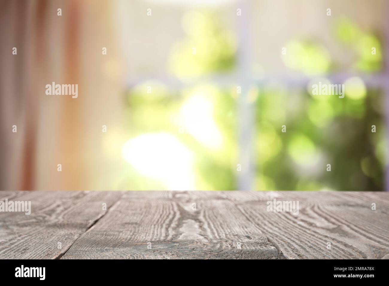 Leerer Holztisch vor dem Fenster. Sonniger Morgen Stockfoto
