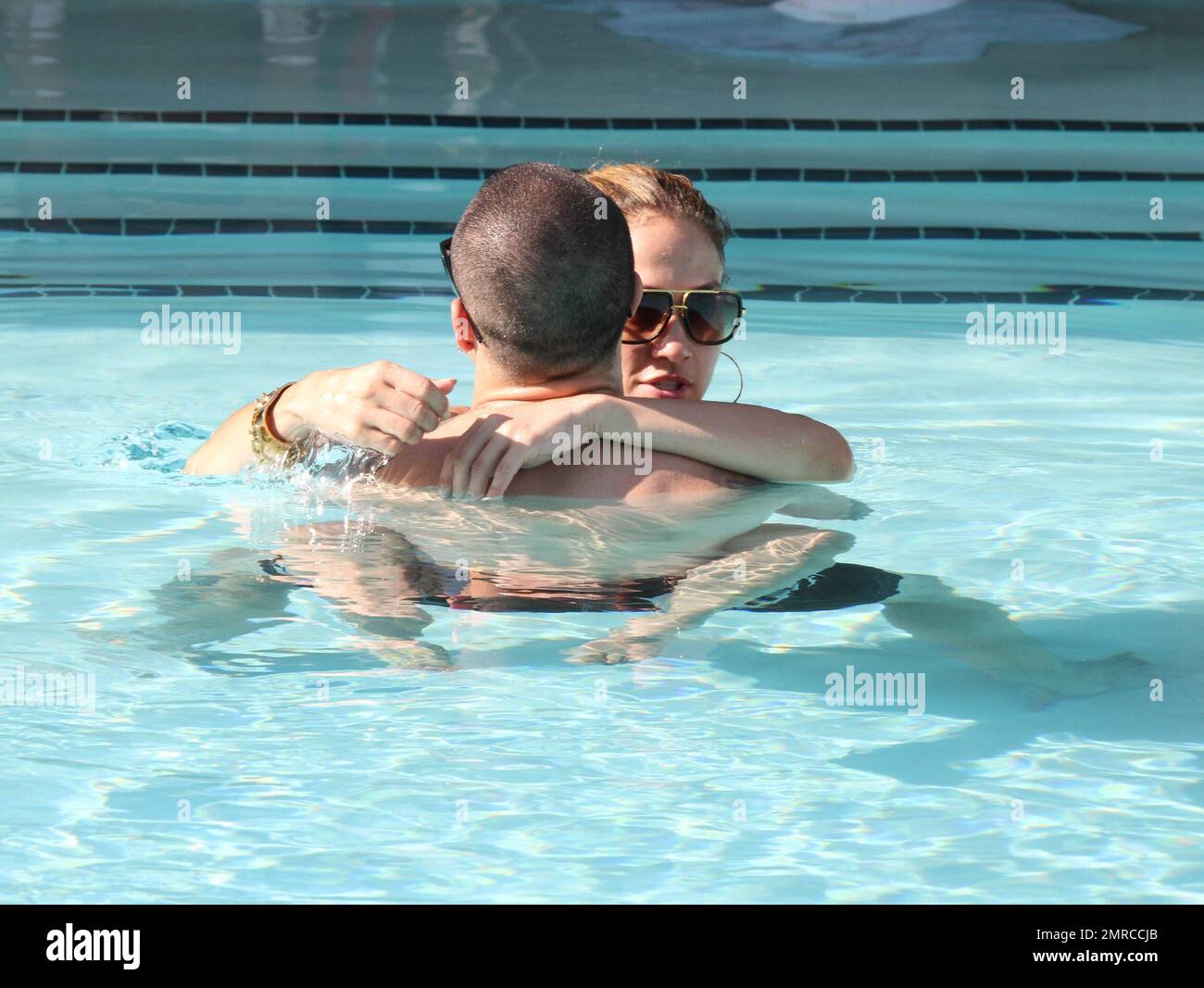Jennifer Lopez entspannt sich am letzten Tag ihrer gemeinsamen Tour mit Enrique Iglesias mit einem Bad im Pool mit ihrem Freund Casper Smart. Die beiden wurden beim Kuscheln und Küssen gesehen, als sie um den Pool schwammen und Jennifer einmal ihre Beine um ihn wickelte. Casper ging vorhin laufen und brachte zwei Flaschen Wasser mit, mit denen er Fotografen beim Vorbeilaufen bespritzte. Jennifers Zwillinge Max und Emme waren den ganzen Nachmittag am Pool und warteten auf ihre mutter, die um 3pm Uhr zu ihnen kam. Miami Beach, Florida 1. September 2012 Stockfoto