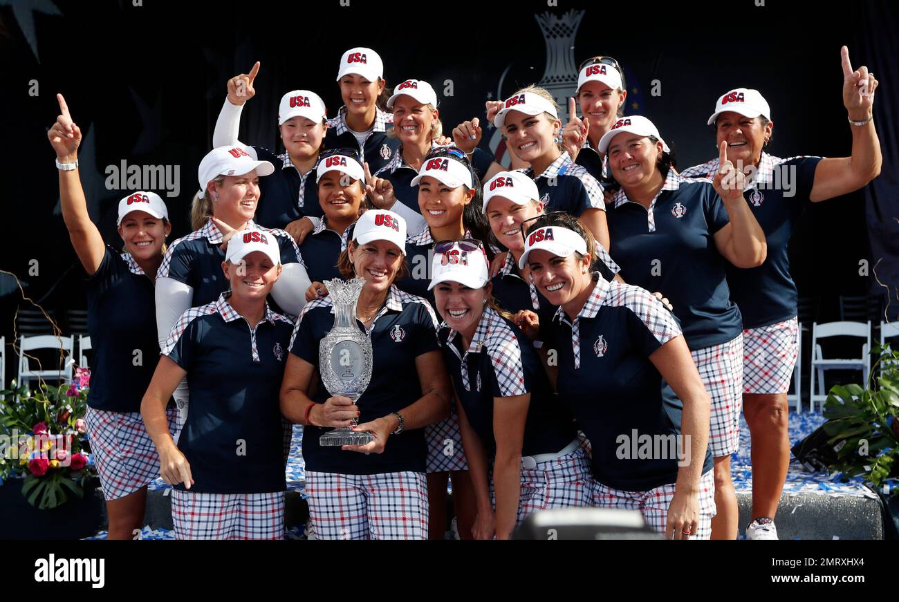 United States captain Juli Inkster, center, holds the Solheim Cup as she celebrates with her team after winning the Solheim Cup golf tournament, Sunday, Aug. 20, 2017, in West Des Moines, Iowa. (AP Photo/Charlie Neibergall) Stockfoto