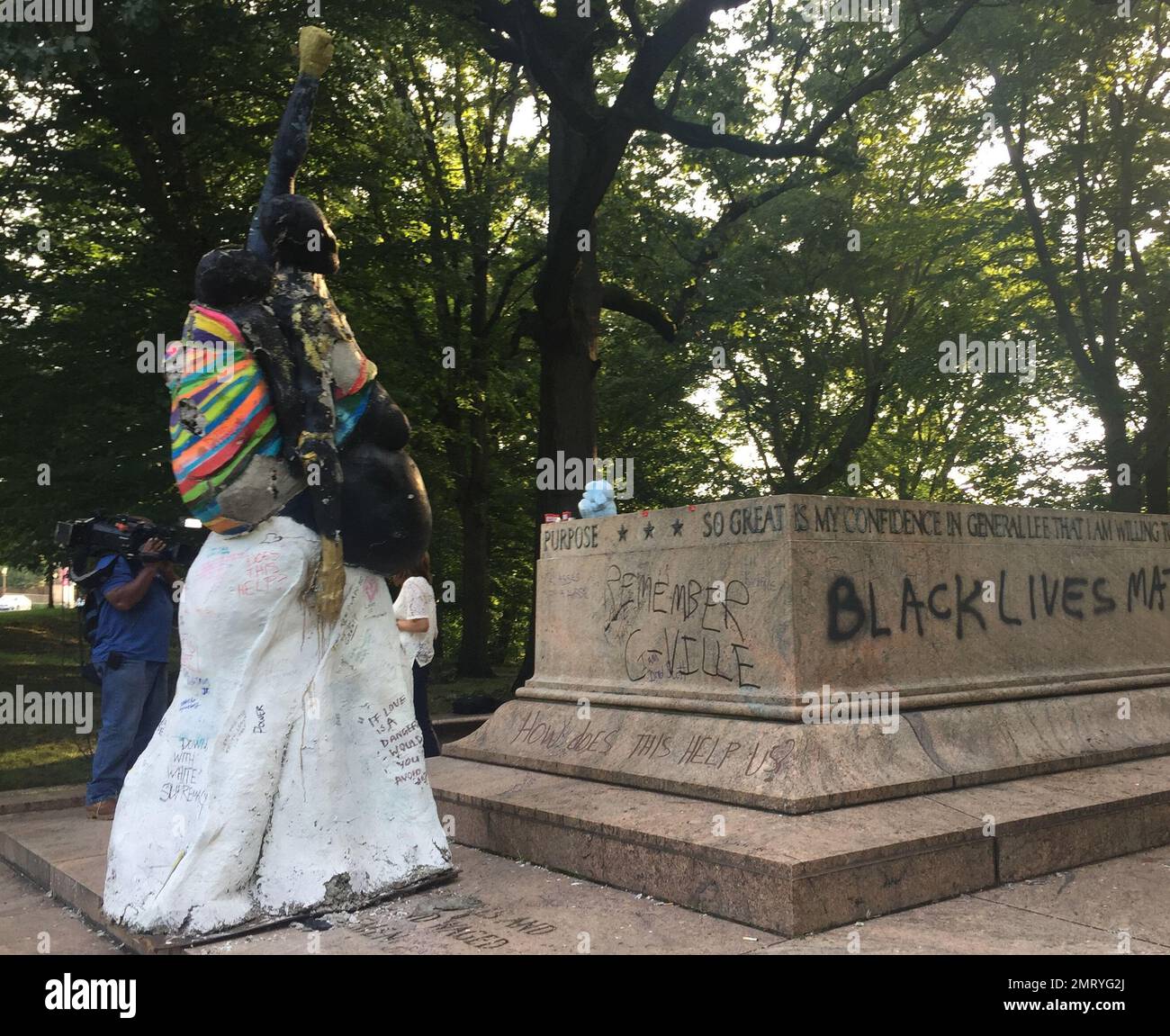 Light shines through the trees near a Confederate statue Wednesday, Aug