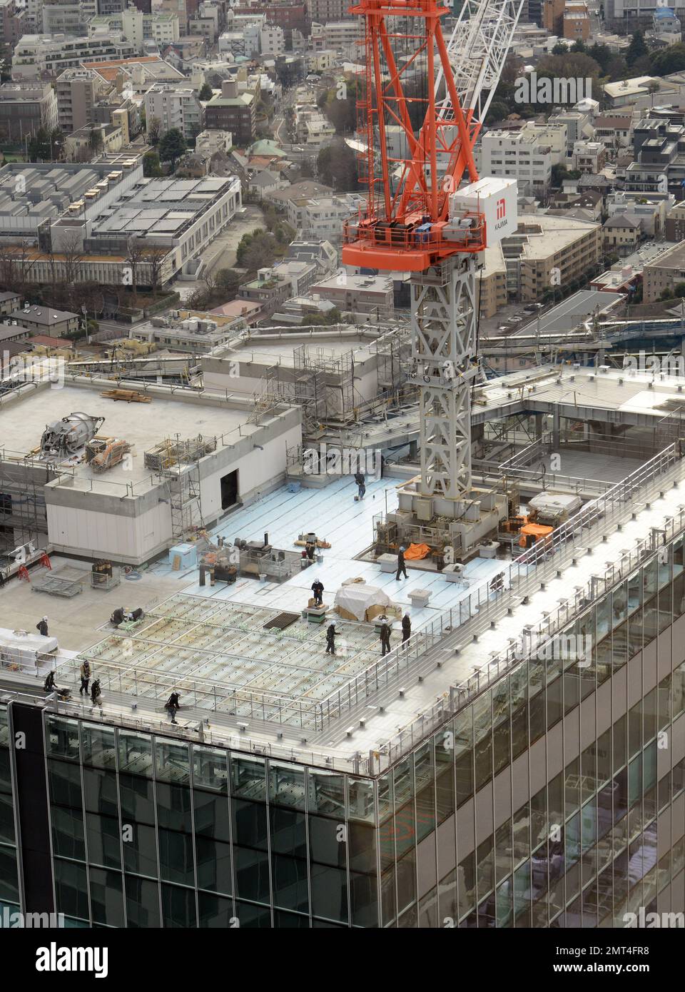 Bauarbeiter, die auf dem Dach eines neuen Wolkenkratzers in Shibuya, Tokio, Japan arbeiten. Stockfoto
