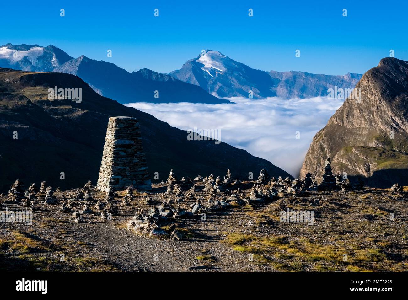 Berge und Hügel der Graianischen Alpen, von Col de L'Iseran aus gesehen 2770 m, der höchste asphaltierte Pass in den Alpen, das Tal voller Nebel. Stockfoto