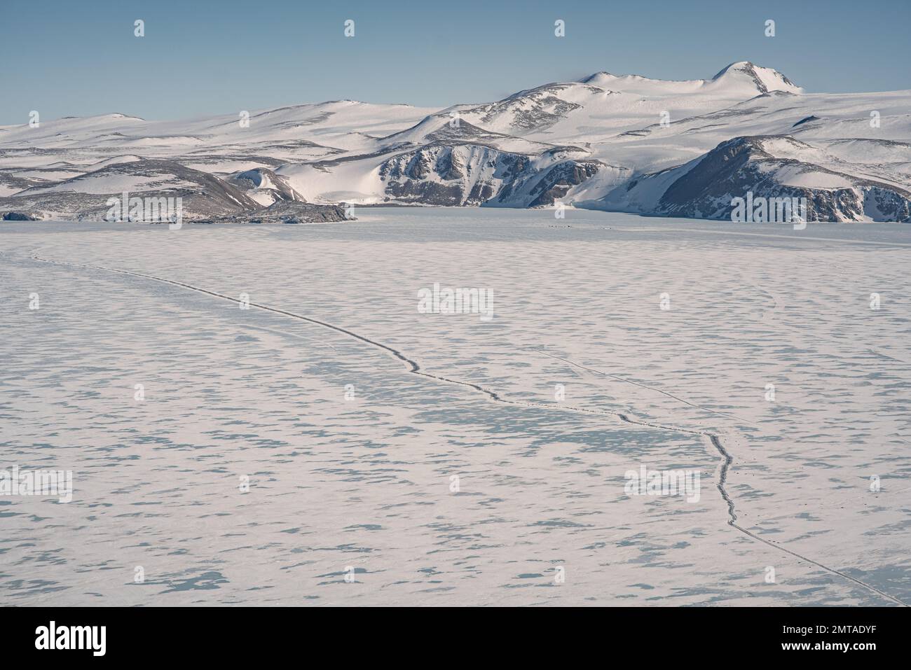 Eine Drohnenaufnahme der schneebedeckten Hügel und der Eisfläche der Terra Nova Bay in der Antarktis Stockfoto