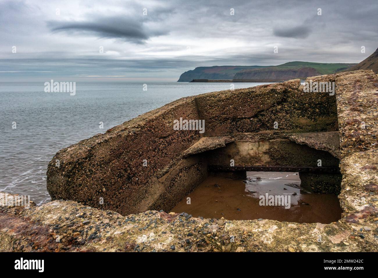 Militärischer Pillkiste am Skinningrove Beach (Cattersty Sands) in Teeside halb im Sand vergraben. Redcar und Cleveland, North Yorkshire. England, Großbritannien Stockfoto