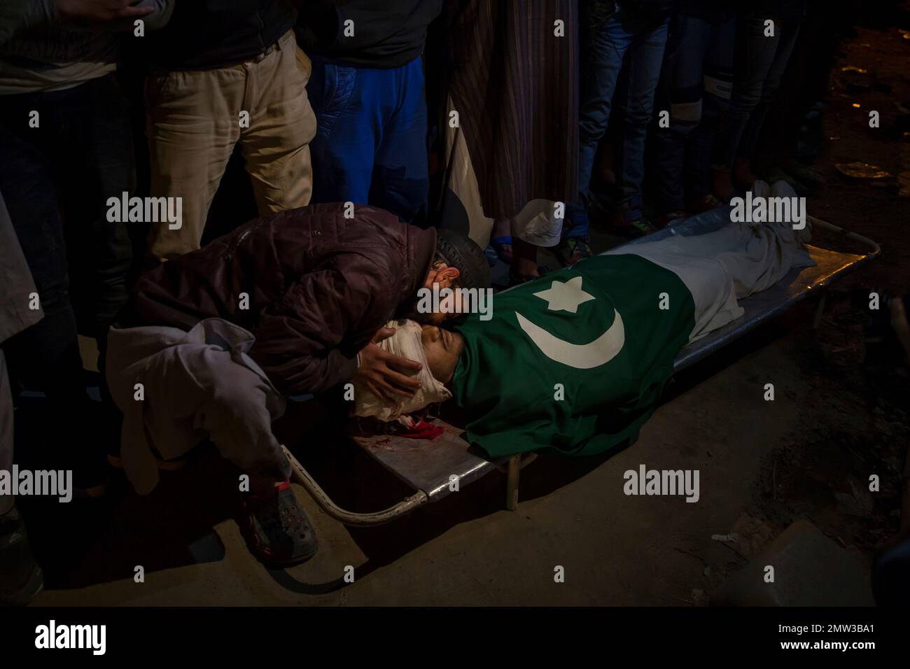 A Kashmiri man kisses the body of Shabir Ahmed, a teenage boy during ...