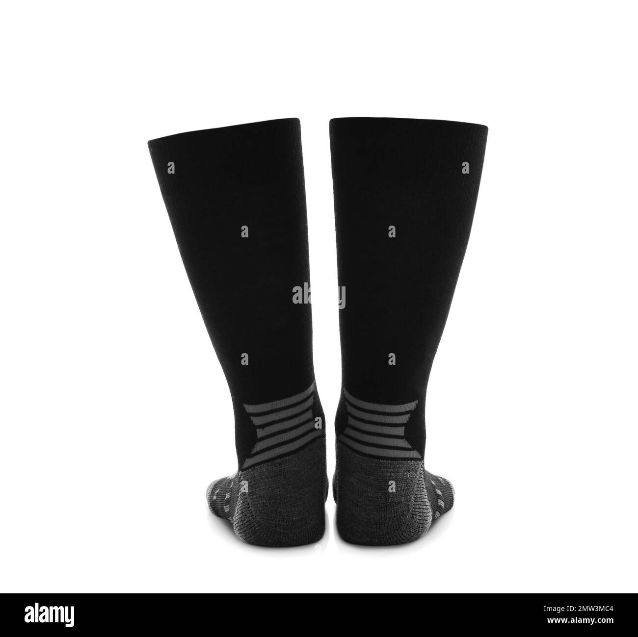Frau trägt Thermosocken auf weißem Hintergrund, Nahaufnahme der Beine. Wintersportkleidung Stockfoto