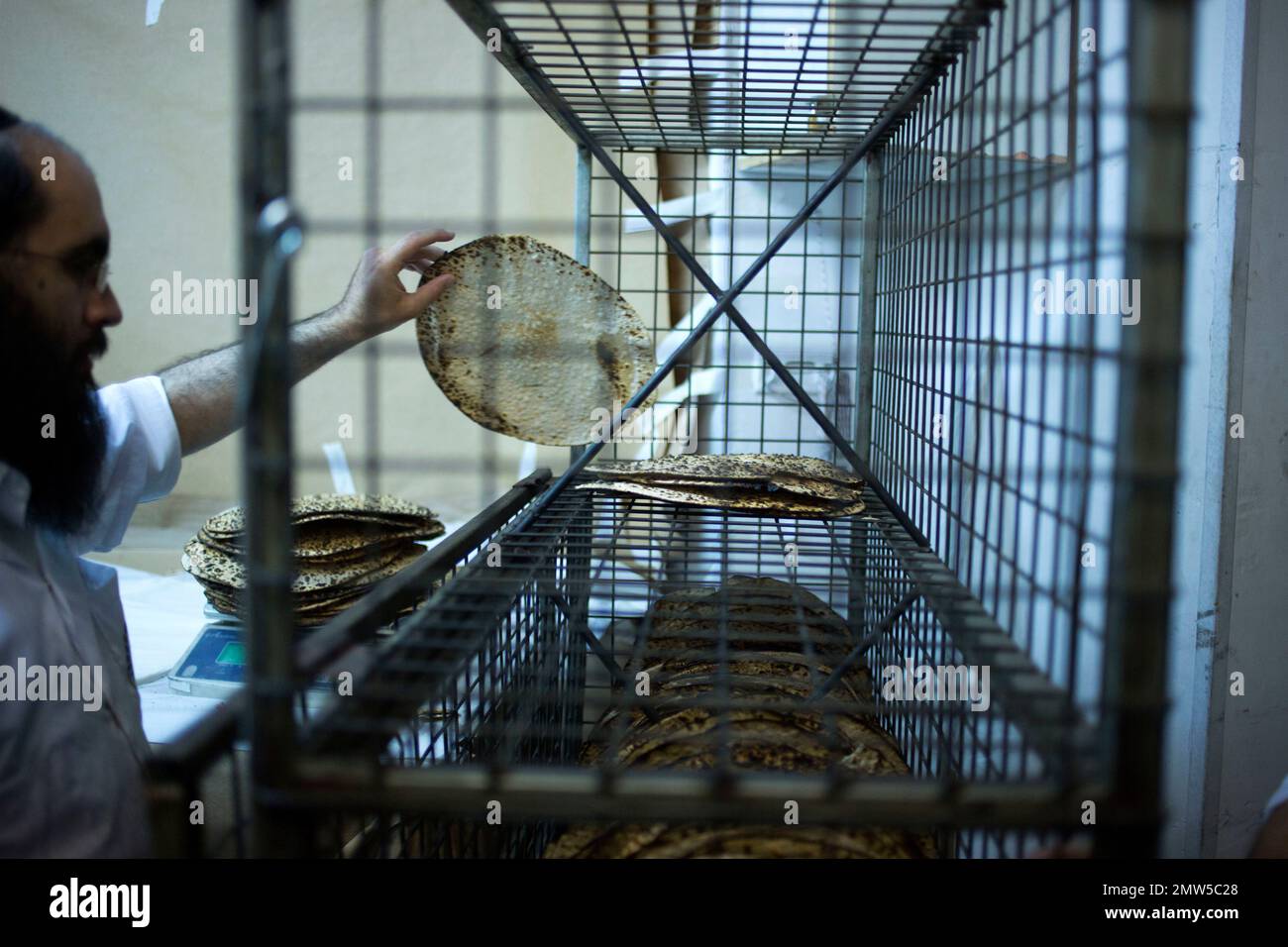 A Jewish Orthodox baker makes matzo, a traditional handmade Passover