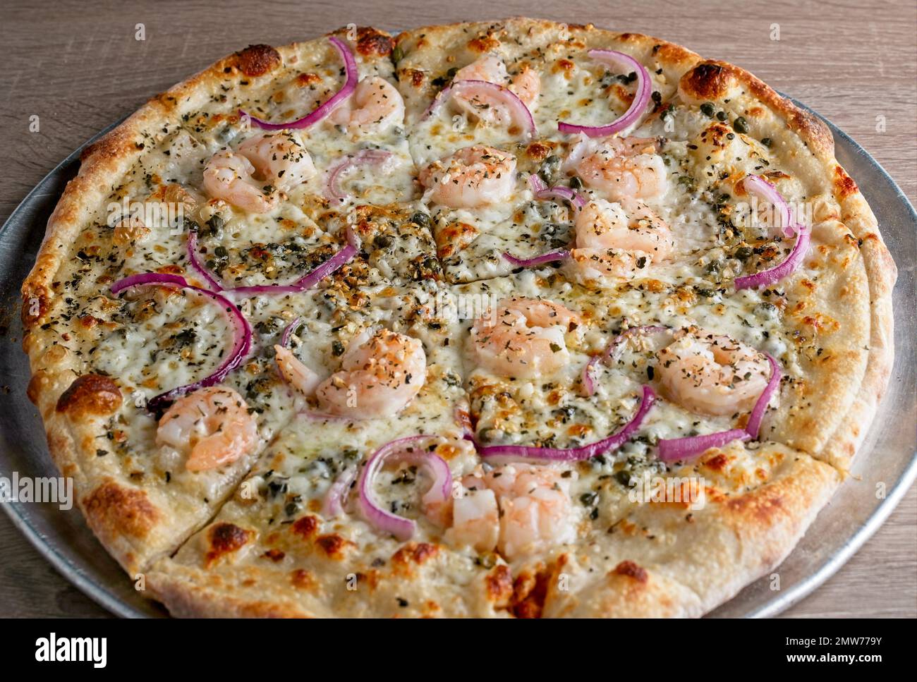 Weiße Gourmet-Pizza-Pastete mit Garnelen, roten Zwiebeln, Kapern und Zitrone Stockfoto
