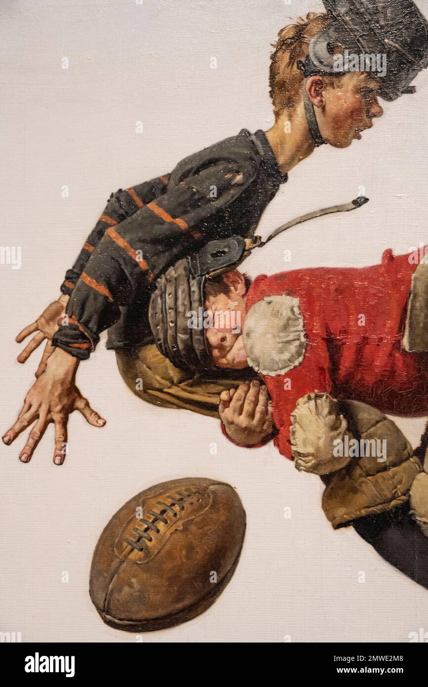Das Gemälde von Norman Rockwell trägt den Titel „Boy Making Football Tackle“ und wurde 1925 für die Zeitschrift Saturday Evening Post produziert. Stockfoto