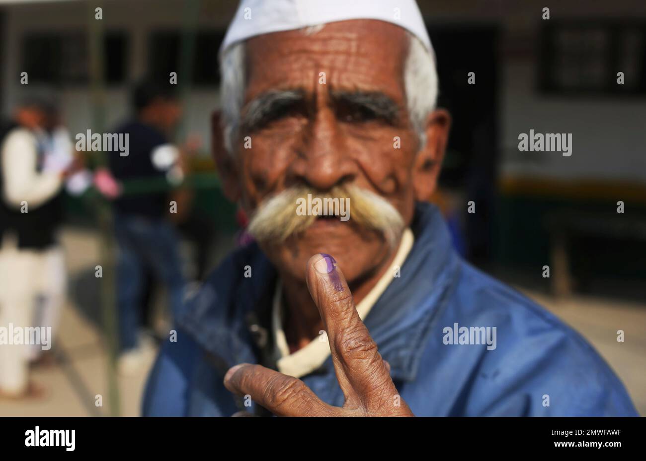An Elderly Indian Man Shows His Finger Marked With Indelible Ink After an-elderly-indian-man-shows-his-finger-marked-with-indelible-ink-after