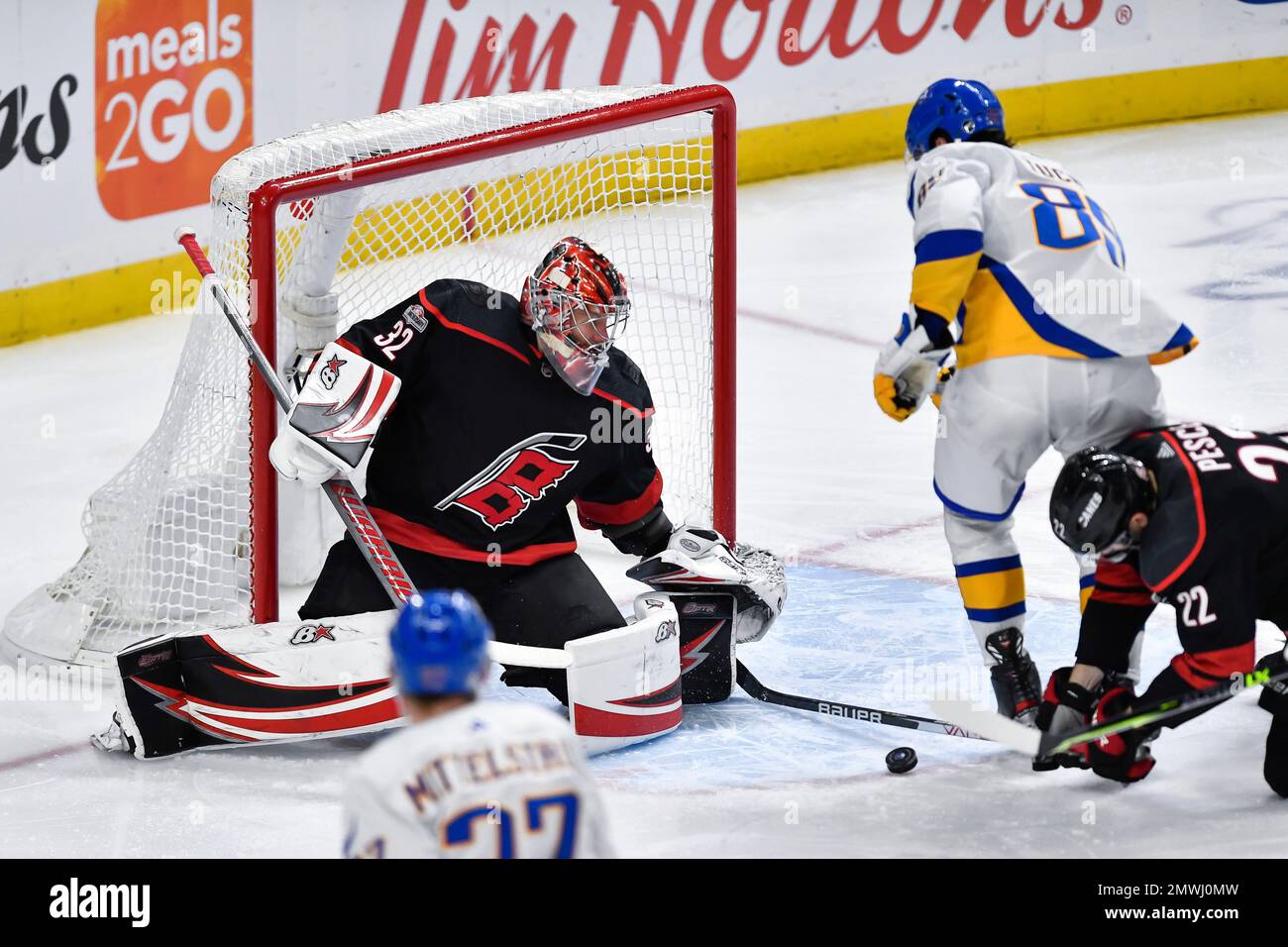 Carolina Hurricanes goalie Antti Raanta, left, tracks the loose puck