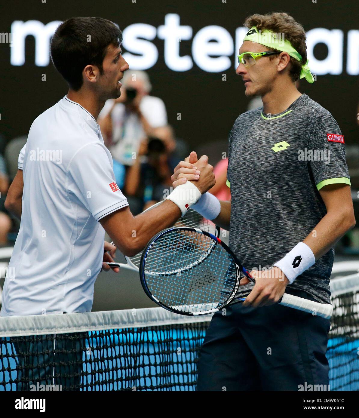Uzbekistan's Denis Istomin, right, is congratulated by Serbia's Novak Djokovic after winning their second round match at the Australian Open tennis championships in Melbourne, Australia, Thursday, Jan. 19, 2017. (AP Photo/Mark Baker) Stockfoto