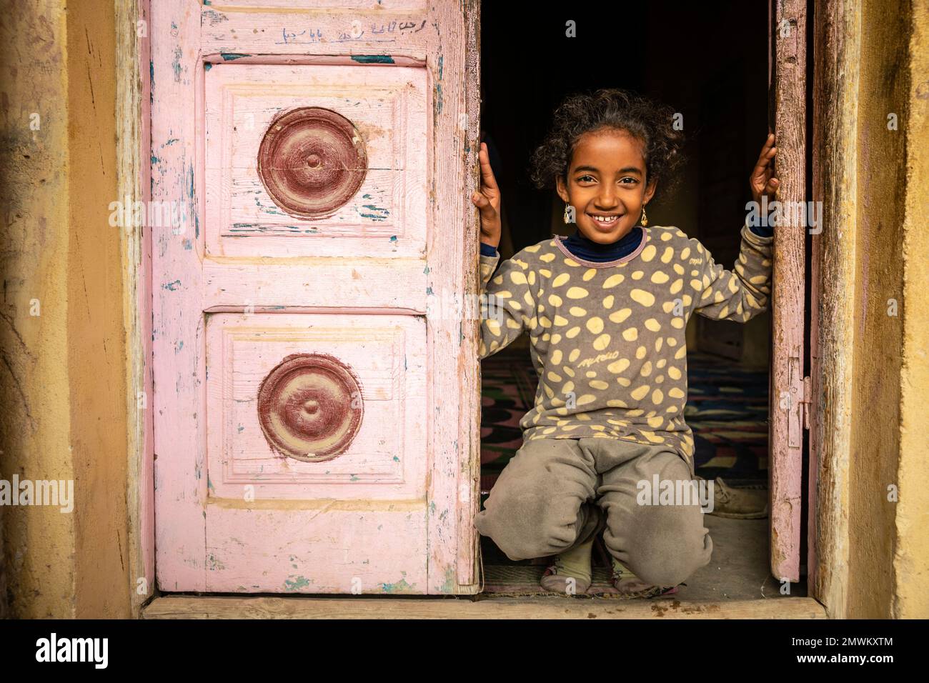 Ein junges Mädchen im Eingang des Dorfes Tunis, Qarun-See, Ägypten Stockfoto