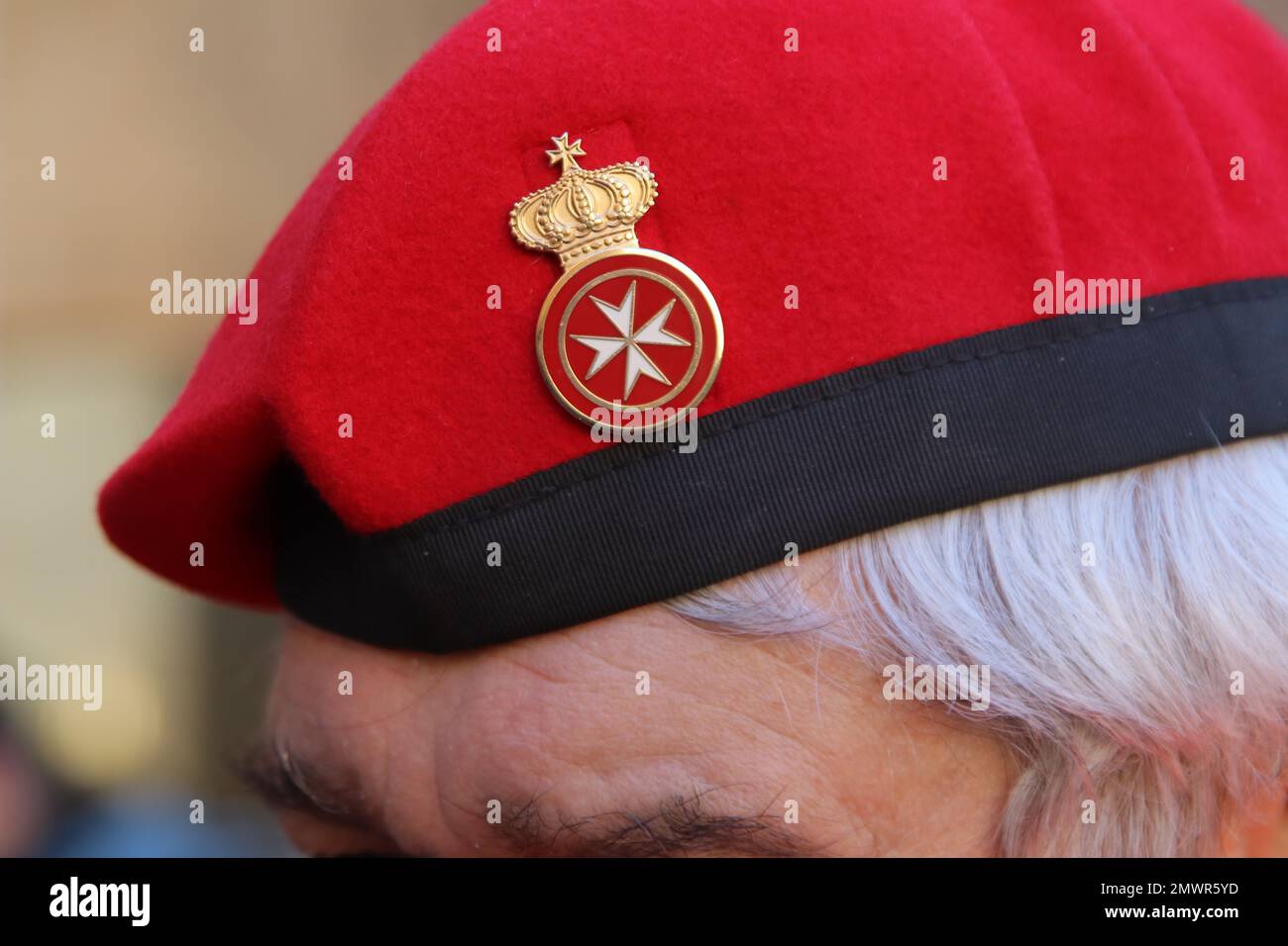 Malteserorden-Service-Pin auf dem roten Hut Stockfoto