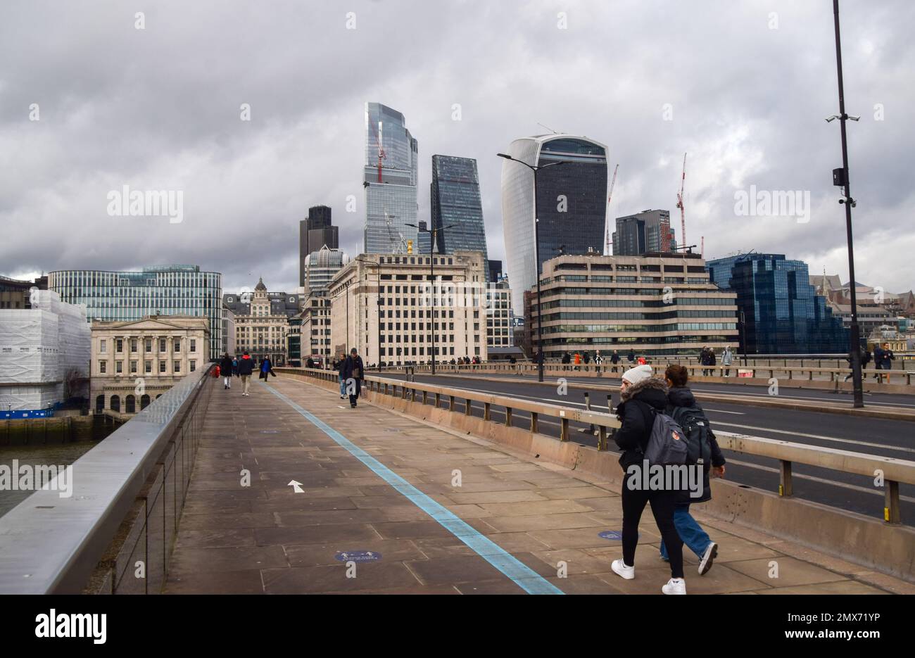 London, Großbritannien. 2. Februar 2023 Die Leute gehen entlang der London Bridge vorbei an der Skyline der City of London, dem Finanzviertel der Hauptstadt, während die Bank of England die britischen Zinssätze auf 4% erhöht. Kredit: Vuk Valcic/Alamy Live News. Stockfoto