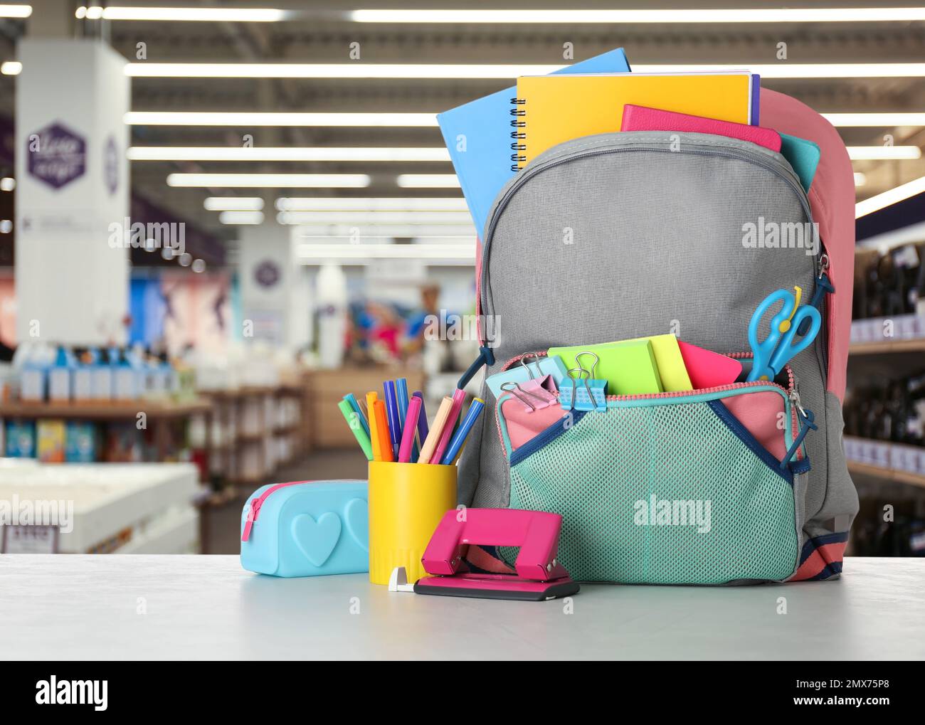 Heller Rucksack mit Schulpapier auf dem Tisch im Einkaufszentrum Stockfoto