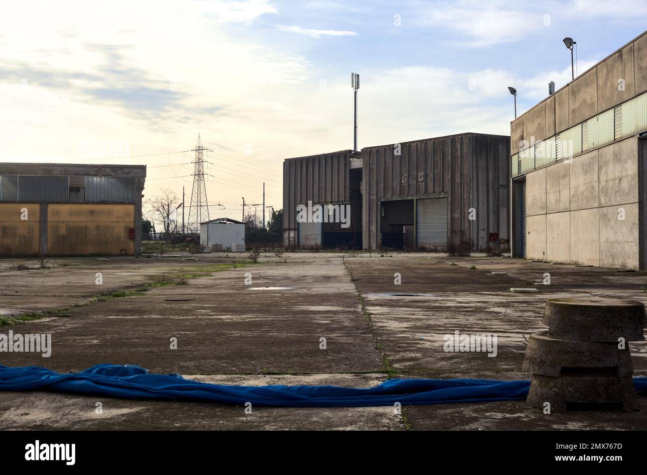 Verlassenes Industriegelände, das durch ein Tor auf dem italienischen Land geschlossen ist Stockfoto